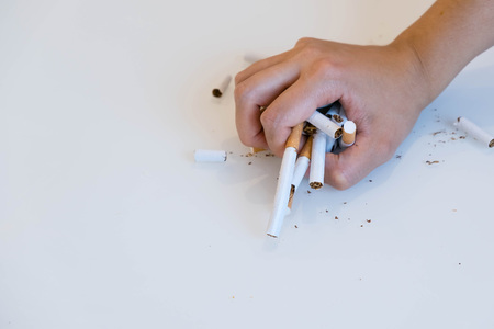 broken scattered cigarettes, tobacco, close-up on a black background. Top view with copy space, flat lay. STOP Smoking. World no tobacco day.の写真素材