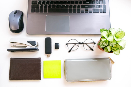 Flat lay, top view office table desk frame. feminine desk workspace with laptop, diary, succulent, glasses, watch on white background.の写真素材