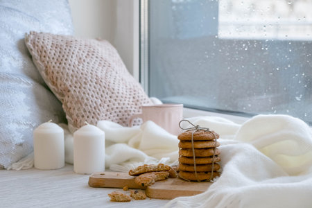 cozy winter still life: warm woolen knitting, hot tea, red book, Christmas cookies and music....