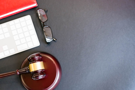 justice and law concept.Lawyer workplace with laptop and documents with dark woodenの写真素材