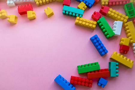 Close up Children plastic constructor. on a pink background stripe background. Developing toysの写真素材