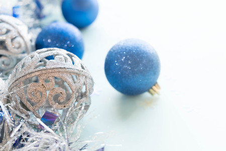 Blue and silver xmas ornaments on bright holiday background with space for text. Merry christmas!の写真素材