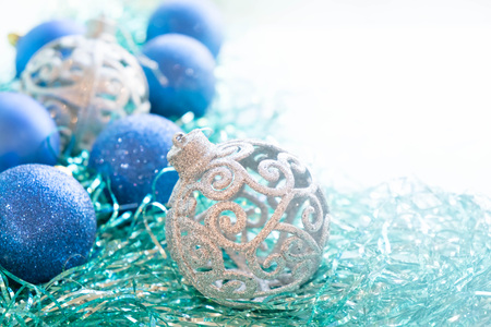 Blue and silver xmas ornaments on bright holiday background with space for text. Merry christmas!の写真素材