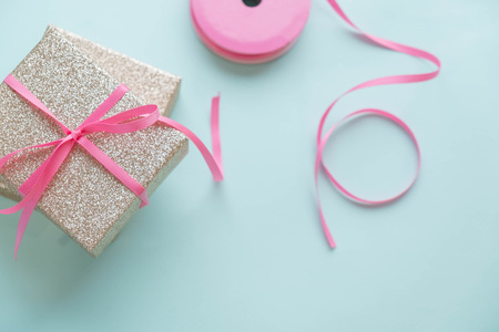 Gold gift box and a small Bell tied a red bo lay on the wood White and pine Christmas dayの写真素材
