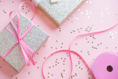 Gold gift box and a small Bell tied a red bo lay on the wood White and pine Christmas dayの写真素材