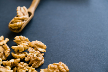 Whole Walnuts and Cleared Black Wooden Background Top view Healthy concept. Natural light. Selective focus. Close up on a black background. Top view, flat lay. copy spaceの写真素材
