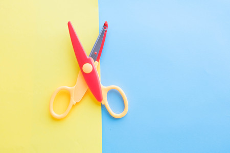 The child makes decoration. scissors, colored paper. art project, a craft for childrenの写真素材