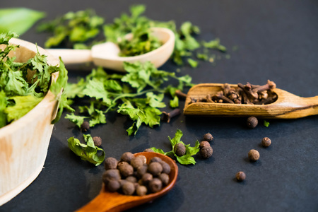 black pepper in spoon, parsley herb. Top view with copy spaceの写真素材