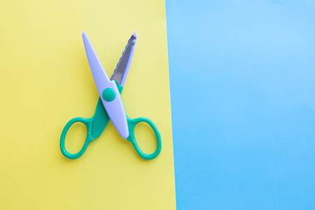 The child makes decoration. scissors, colored paper. art project, a craft for childrenの写真素材