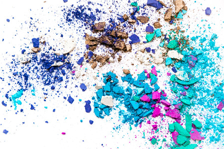 Samples of dry blush, powder, bronzers and highlighter scattered in a line isolated on a white backgroundの写真素材