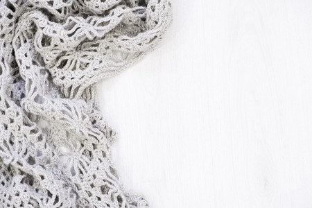 Cozy soft plaid on white wooden background. winter knitted sweater old vintage wooden board. Christmas holidays at home. place for text, Top view flat lay with copy space for slogan or textの写真素材