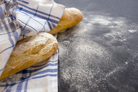 Sliced bread over dark stone table. View from above with copy spaceの写真素材
