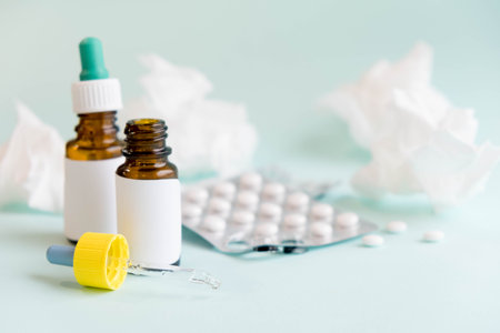 Spray for the nose or a pill to treat colds and gripes. Glass Bottle with medicines and paper...