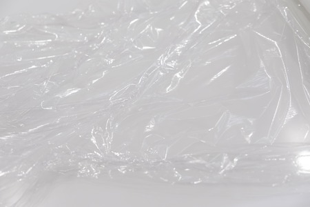 wrapping plastic transparent food film on white background.の写真素材