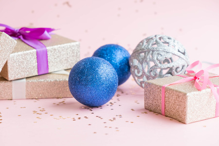 Gold gift box and a small Bell tied a red bo lay on the wood White and pine Christmas dayの写真素材