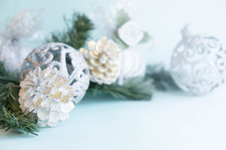 White christmas ornaments on light blue background with colorful bokeh lights. Merry christmas card. Winter holiday xmas theme. Space for text. Happy New Year.の写真素材