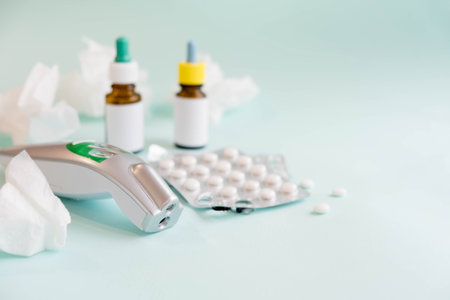Spray for the nose or a pill to treat colds and gripes. Glass Bottle with medicines and paper...