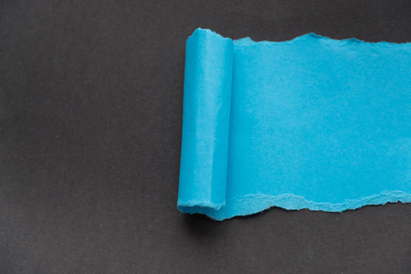 blue rip paper isolated on black background with space for textの写真素材