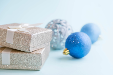 Gold gift box and a small Bell tied a red bo lay on the wood White and pine Christmas dayの写真素材