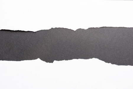 Piece of torn paper on black. Copy spaceの写真素材