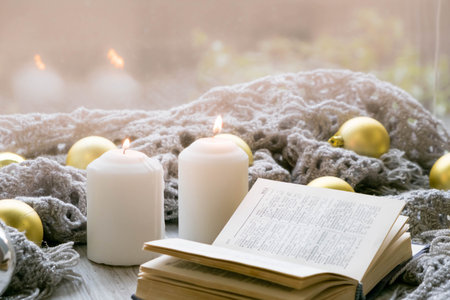 Interior of room with cozy window sill, cup of tea, books, candels, homely comfy rest conceptの写真素材