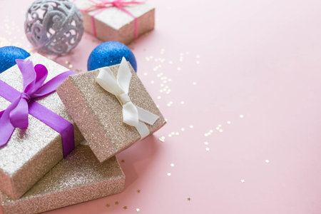 Gold gift box and a small Bell tied a red bo lay on the wood White and pine Christmas day