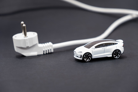 Electric car charging battery hybrids concept on wooden vintageの写真素材