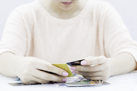 Female arm hold bunch of credit cards picking one closeup. Convenient set of funds budget wallet deposit wealth and effective investment invest resources income profit conceptの写真素材