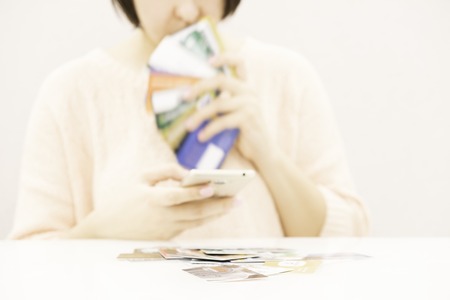 Female arm hold bunch of credit cards picking one closeup. Convenient set of funds budget wallet deposit wealth and effective investment invest resources income profit conceptの写真素材