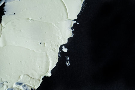 Smear clay mask for face and body. texture is smeared isolated on a black background. natural...