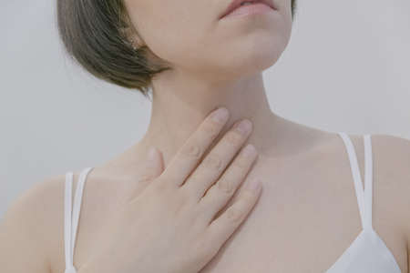 The Photo Of Goitre On Woman's Body Isolate On White Background, Windpipe, Concept with Healthcare And Medicineの写真素材