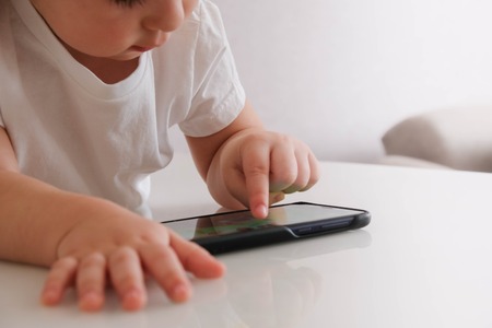 Asian Boy Playing Cell Phoneの写真素材