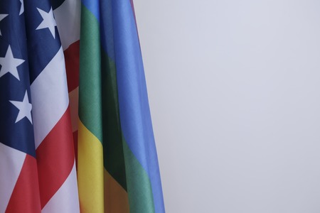 closeup of a gay pride flag and a flag of the United States of Americaの写真素材