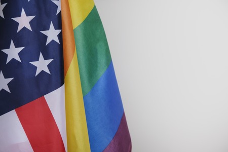 closeup of a gay pride flag and a flag of the United States of Americaの写真素材