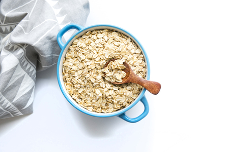 Rolled oats on white wooden backgroundの写真素材