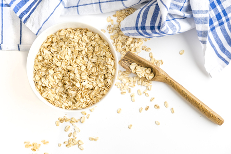 Rolled oats on white wooden backgroundの写真素材