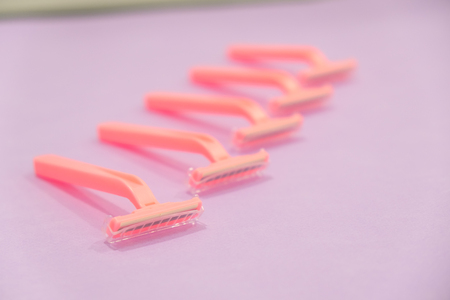 pink womens disposable razors . Hygiene skin body care concept. Hair removal. Focus on razorの写真素材