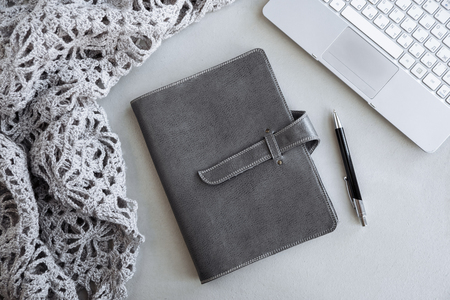 Selective focus table : Businessman hand write notebook, mobile phone, laptop, and pen on the wooden table.working Business concept with effect light addedの写真素材