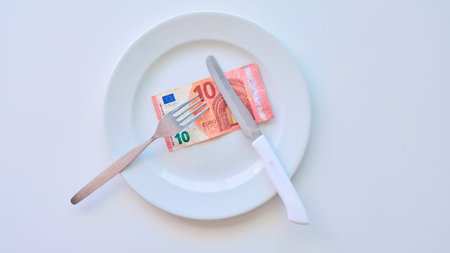 Euro banknote on a white plate, cash in Europe, the cost of lunch in the restaurant