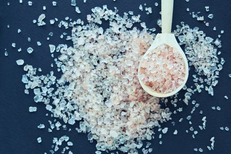 Himalayan pink salt in crystals above a gray stoneの写真素材