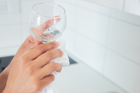 Close up of woman hands washing dishes.の写真素材