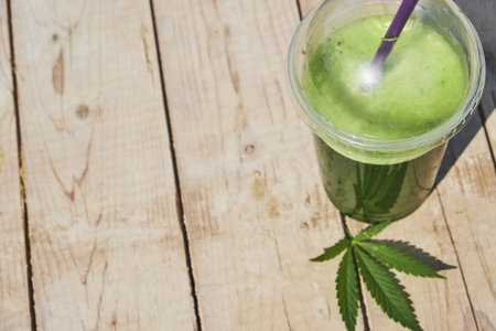 Green marijuana smoothie juice on white backgroundの写真素材