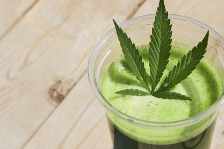 Healthy cannabis smoothie on wooden background. Natural supplement, detox and healthy living.の写真素材