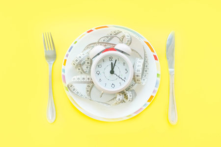 Time to lose weight , eating control or time to diet concept , alarm clock with healthy tool concept...