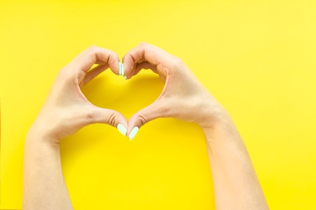 Heart from hands on a white backgroundの写真素材