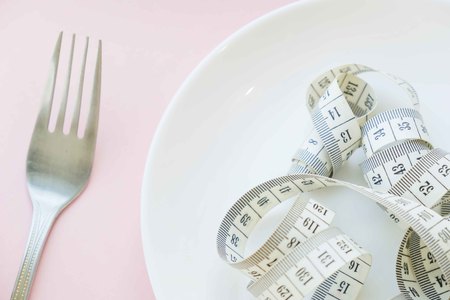 Time to lose weight , eating control or time to diet concept , alarm clock with healthy tool concept decoration on blue backgroundの写真素材