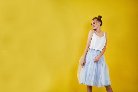 young girl on a yellow bright background. beautiful makeup, bright image, place for textの写真素材