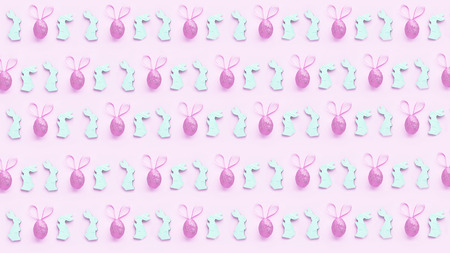 colorful background for easter, wooden bunnies and Easter eggs with earsの写真素材