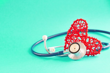 stethoscope and red heart on blue background, medical care concept, staff medical insuranceの写真素材