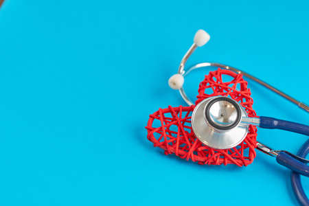 stethoscope and red heart on blue background, medical care concept, staff medical insuranceの写真素材
